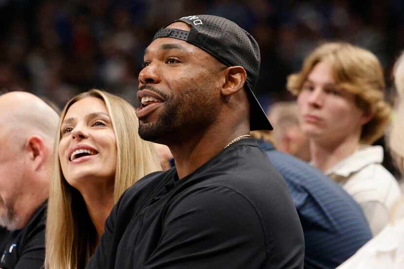 Former Cowboys player Tyron Smith is seen during the first half of an NBA basketball game...