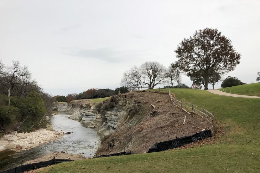The tee shot on the par-5 14th hole at Northwood Club in Dallas will require the golfer to...