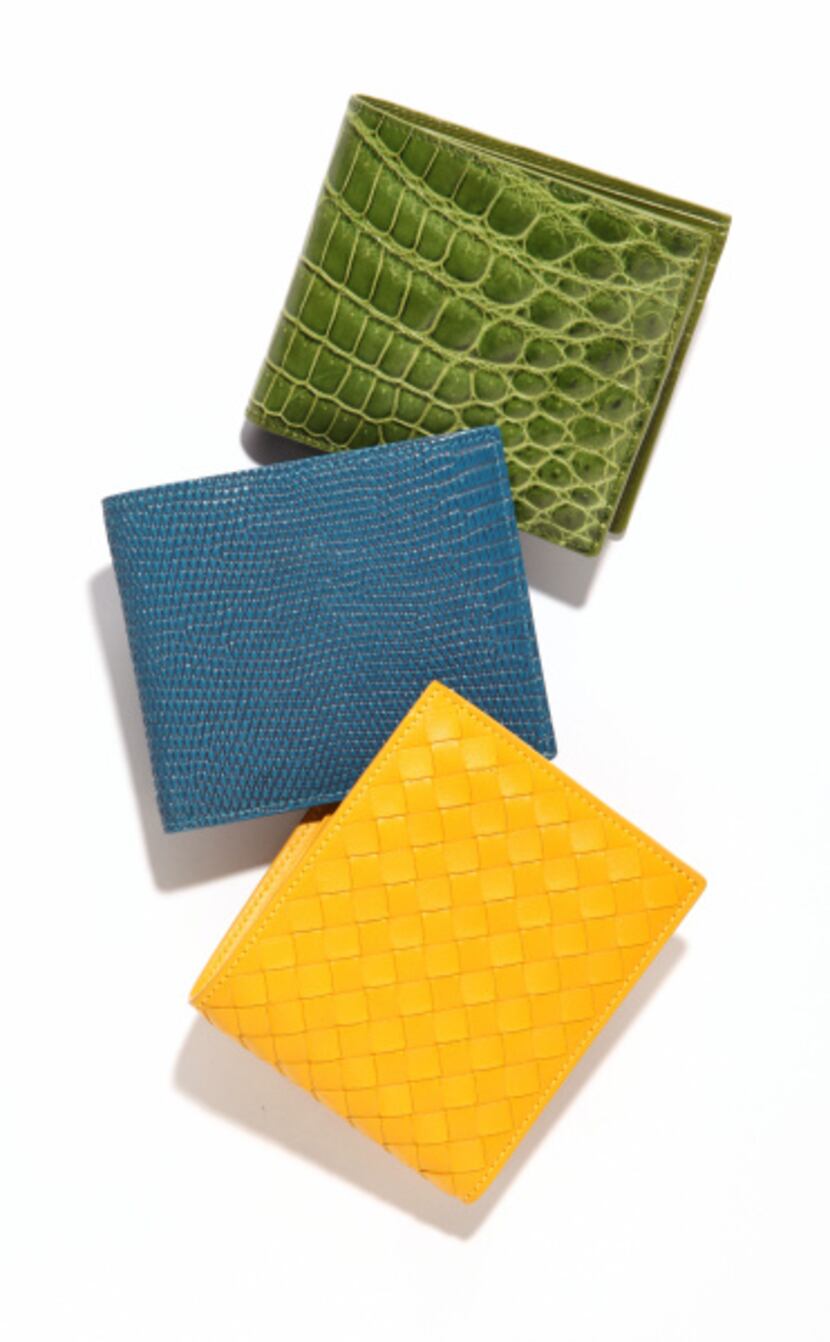 yellow woven wallet, $440, blue lizard wallet, $630, green crocodile wallet, $1,160, all...