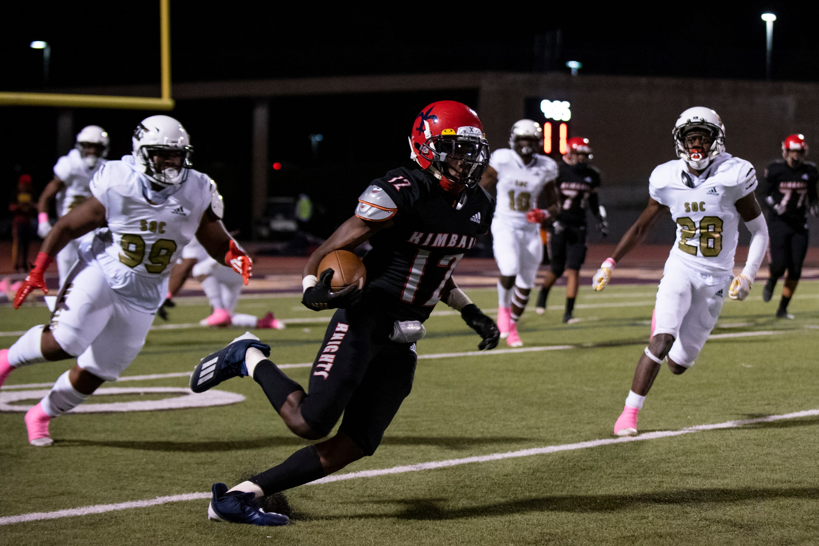 Kimball junior Da’Vonius Dickerson (12) runs up the field to gain yardage during the...