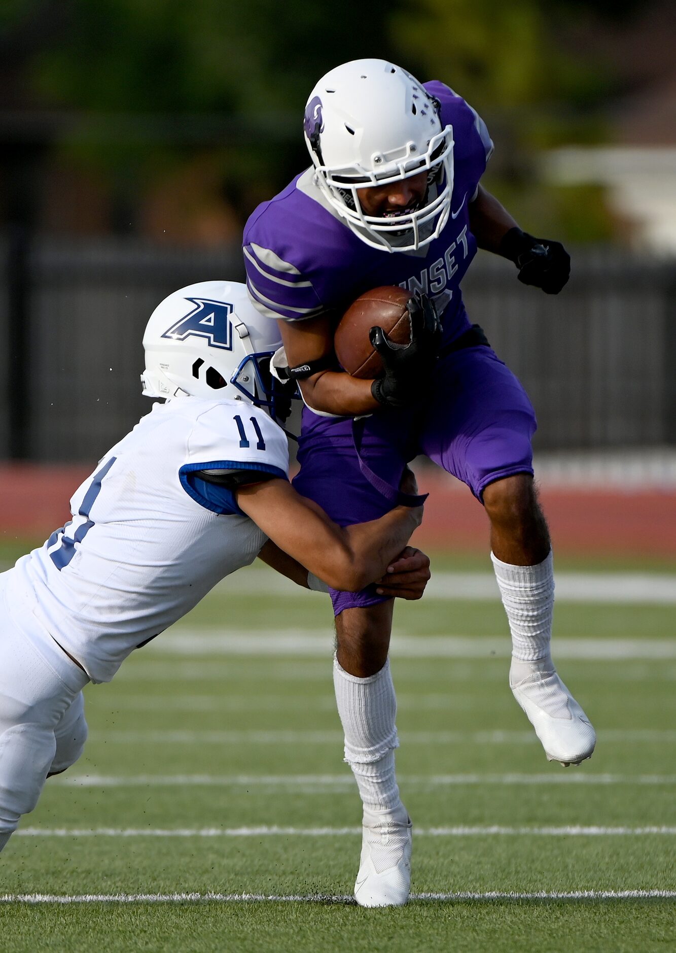 Adamson's Joseph Estrada (11) tackles Sunset's Elias Guerrero (2) in the first half during a...