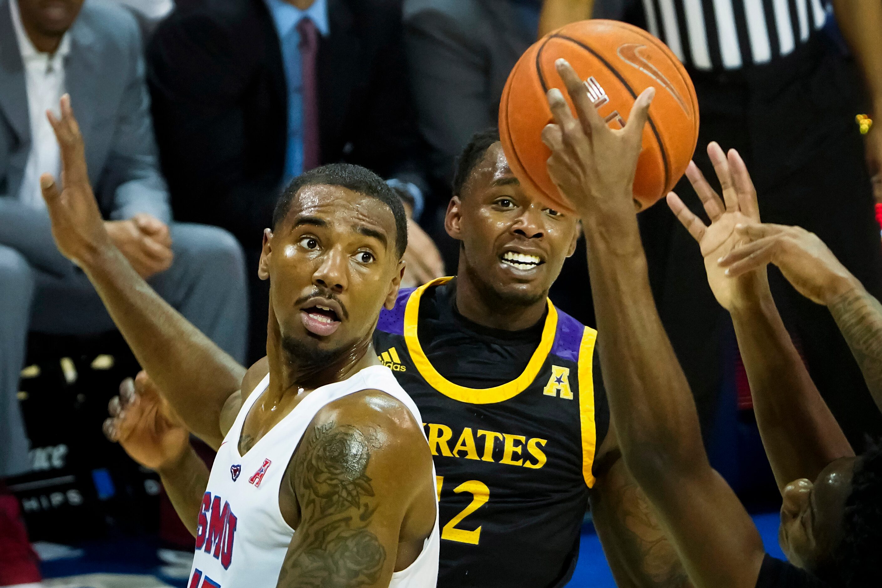 SMU forward Isiaha Mike (15) and East Carolina guard Tremont Robinson-White (12) watch a...