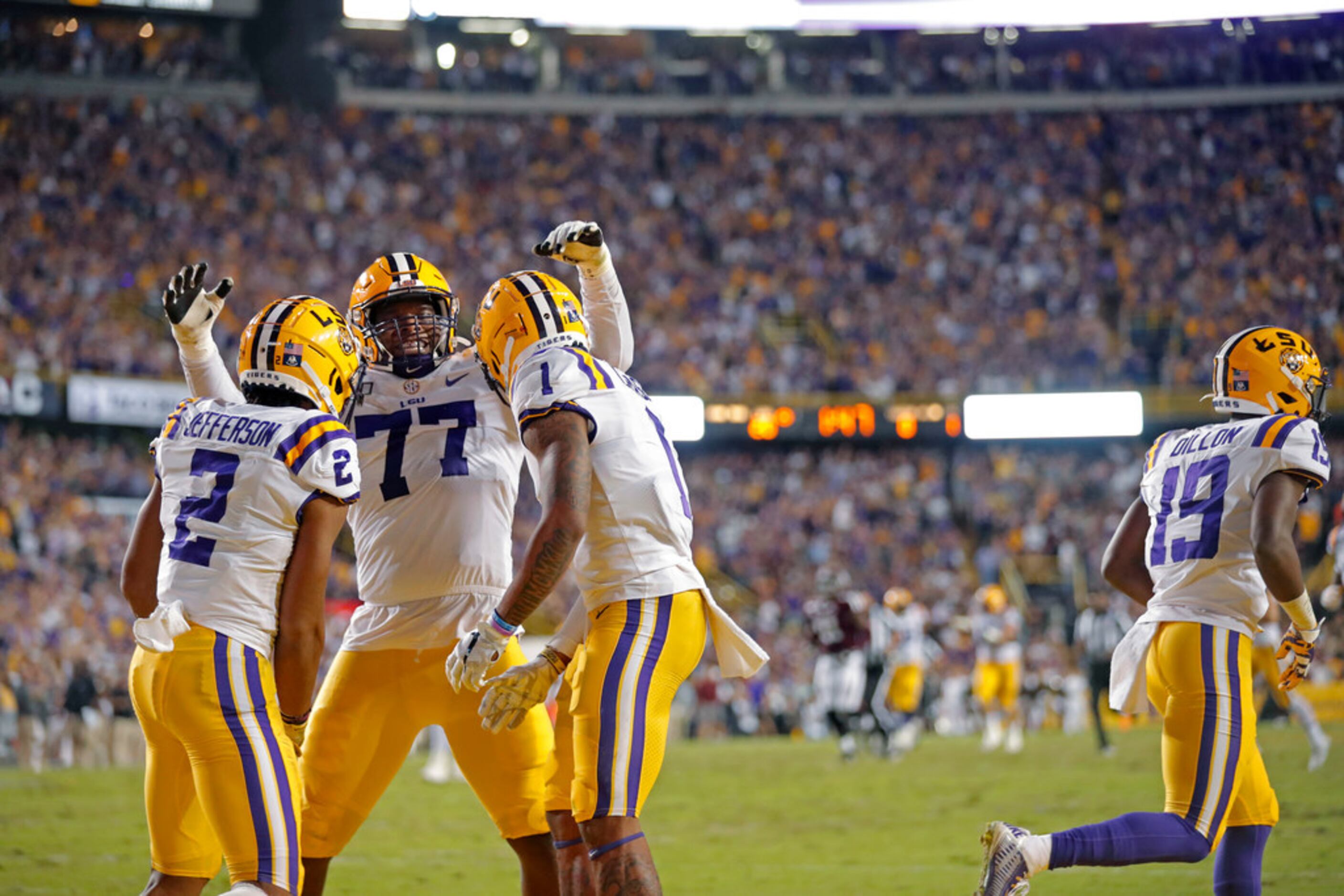 LSU wide receiver Ja'Marr Chase (1) celebrates his touchdown reception with offensive tackle...