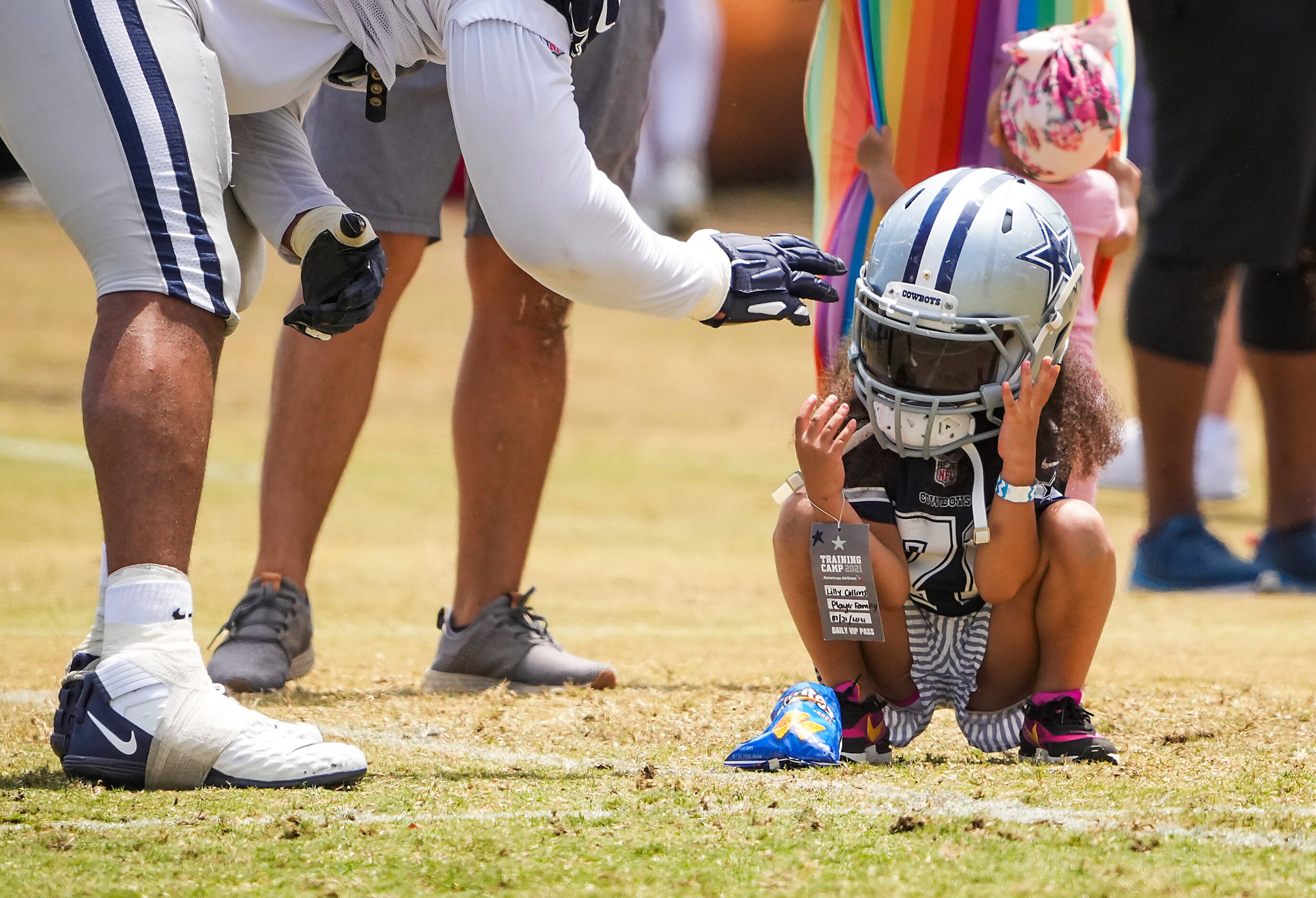 Lilly Collins, daughter of Dallas Cowboys tackle La'el Collins, tries on her father’s helmet...