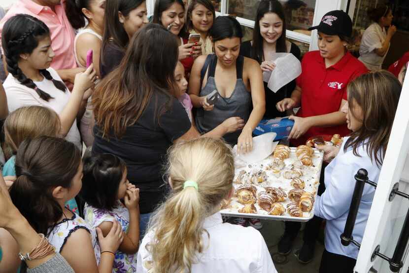 Fans of the TLC show 'Cake Boss' swarmed a Carlo's Bakery employee as they waited for...