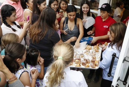 Fans of the TLC show 'Cake Boss' swarmed a Carlo's Bakery employee as they waited for...