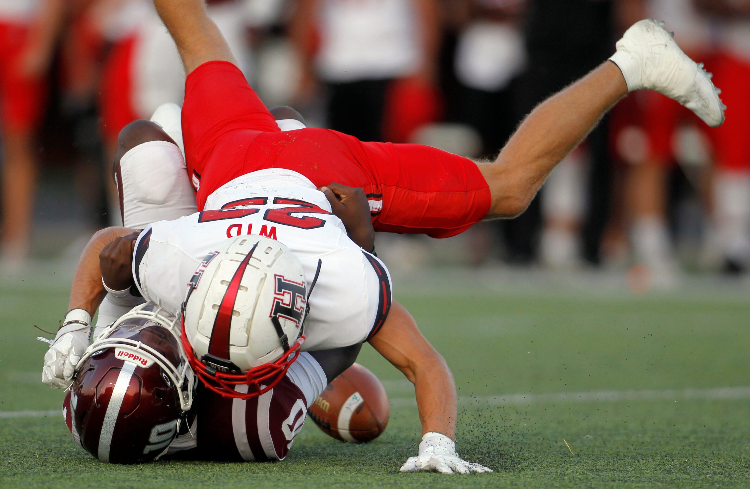 Rockwall Heath linebacker Noah Wilson (23) forces a fumble as he hit Red Oak quarterback...