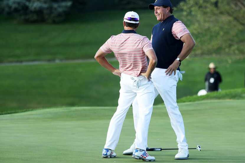 JERSEY CITY, NJ - SEPTEMBER 29:  Phil Mickelson and Kevin Kisner of the U.S. Team celebrate...