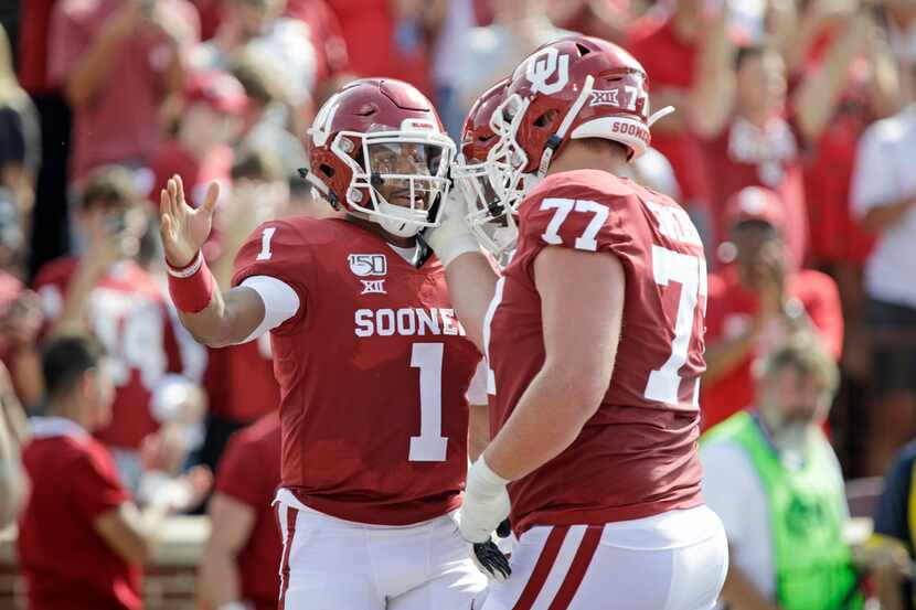 NORMAN, OK - SEPTEMBER 28:  Quarterback Jalen Hurts #2 celebrates his touchdown with left...