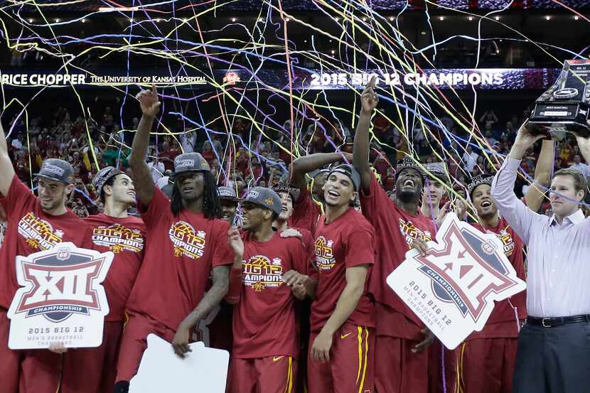 Iowa State players celebrate after winning an NCAA college basketball game against Kansas in...