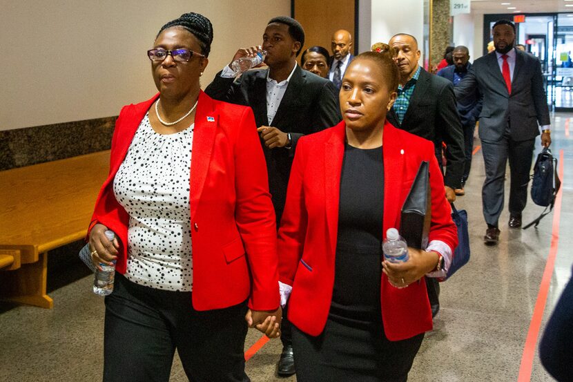 Allison Jean (left), mother of shooting victim Botham Jean, walks with her daughter Allisa...