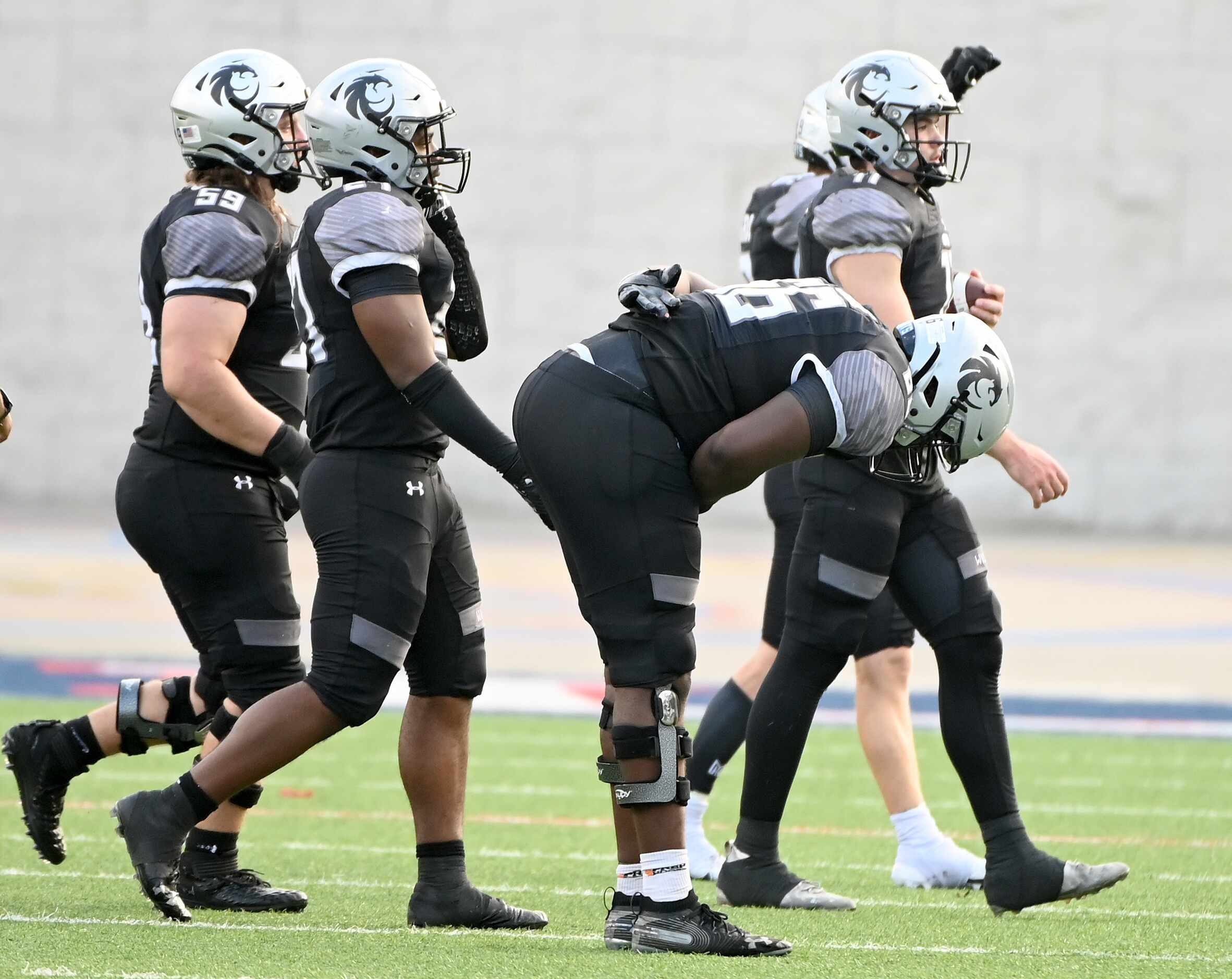 Denton Guyer's Willie Goodacre (66) takes a bow as he walks off the field with teammate...