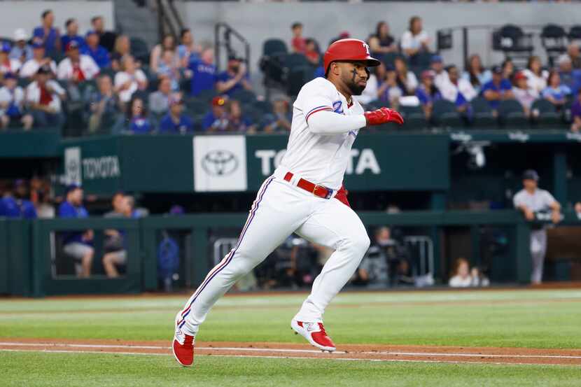 Texas Rangers shortstop Ezequiel Duran singles on a line drive during the first inning of a...