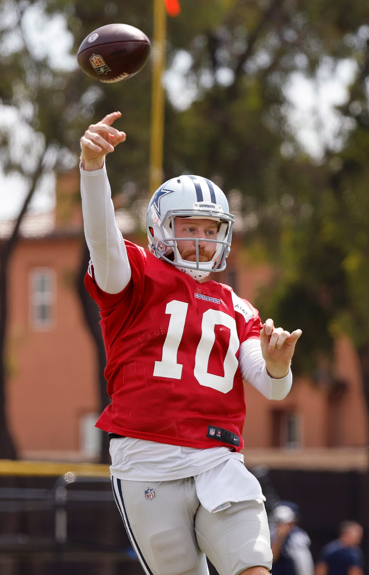 Dallas Cowboys quarterback Cooper Rush (10) throws under pressure during training camp...