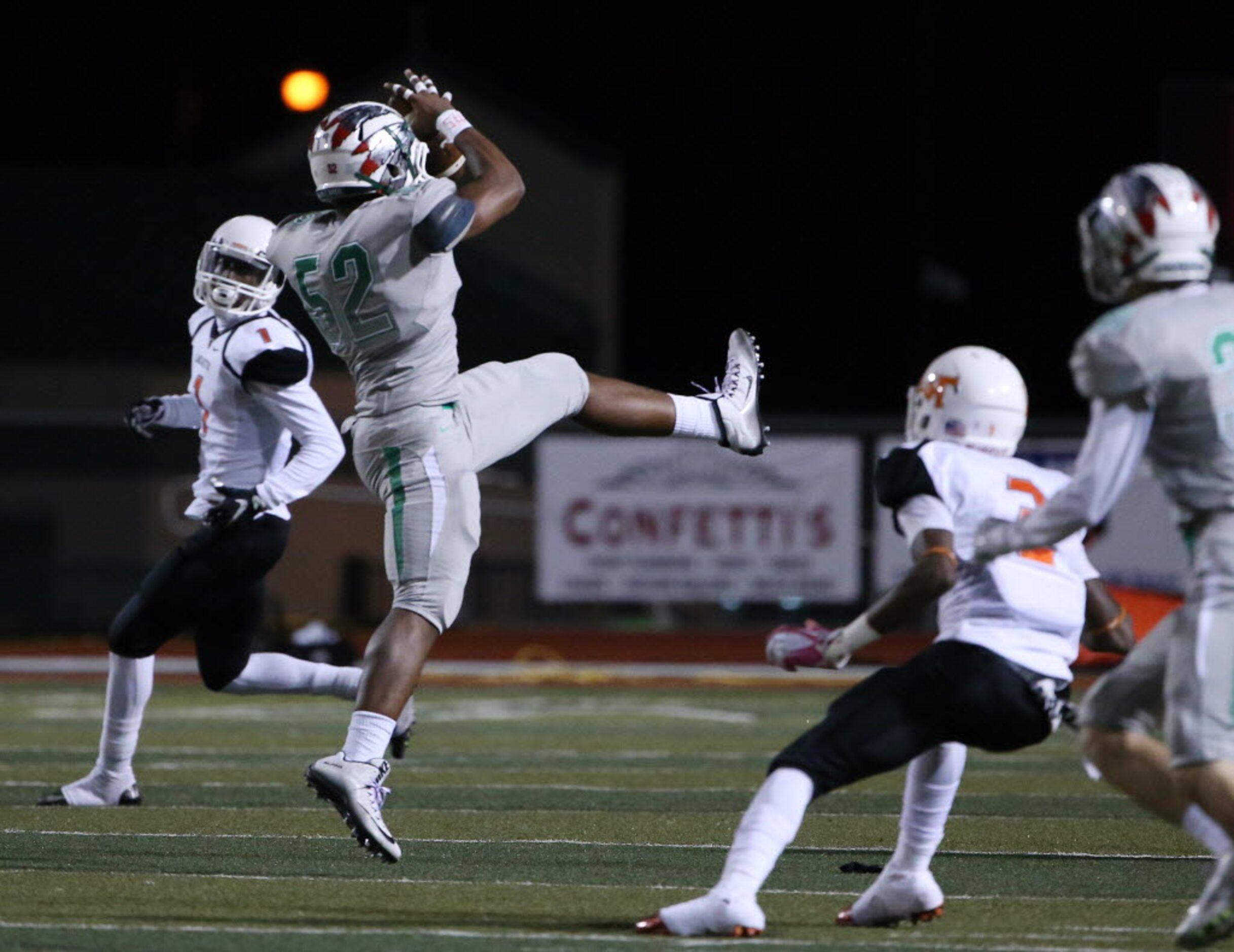 Waxahachie linebacker Caleb High catches an interception on a Lancaster third down and...