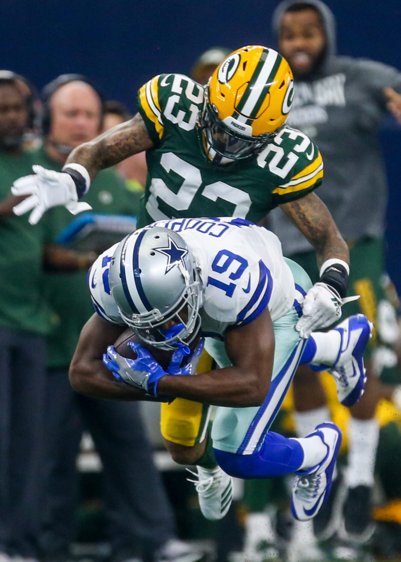 Dallas Cowboys wide receiver Amari Cooper (19) carries the ball as he is defended by Green...