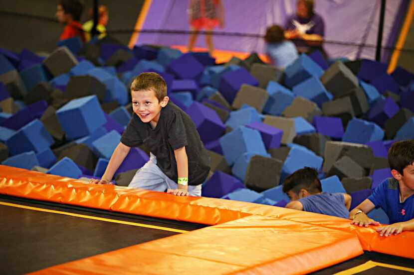 A child emerges from the foam pit and back onto the trampolines at Altitude Trampoline Park...