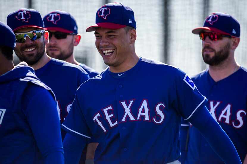 Texas Rangers relief pitcher Keone Kela (50) smiles as he and his teammates warm up during a...