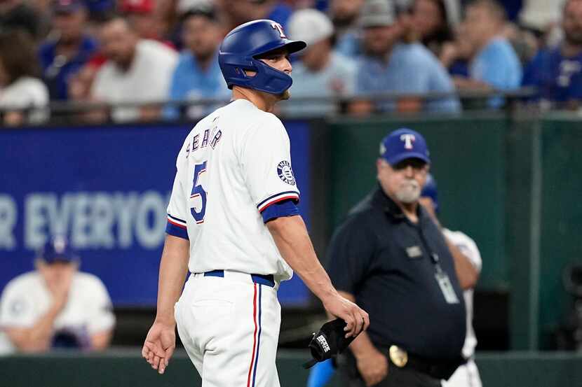 Texas Rangers' Corey Seager leaves the field after hitting an RBI single against the Detroit...