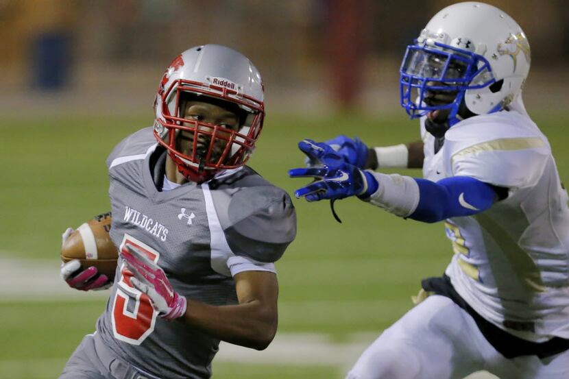 TXHSFB Conrad senior defensive back Younis Sangaray, right, attempts to tackle Woodrow...