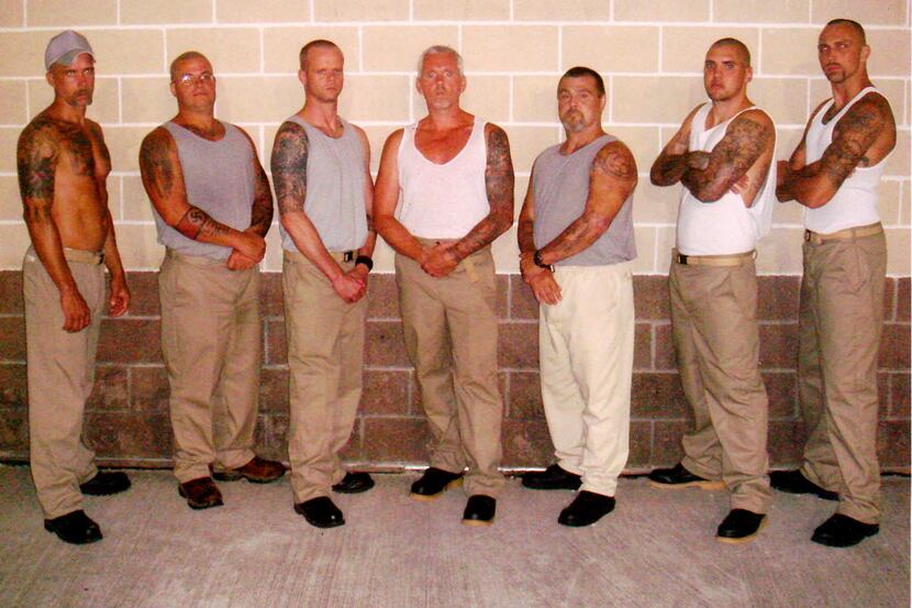 Aryan Brotherhood of Texas general Carl Carver, center, poses with a group of gang members...