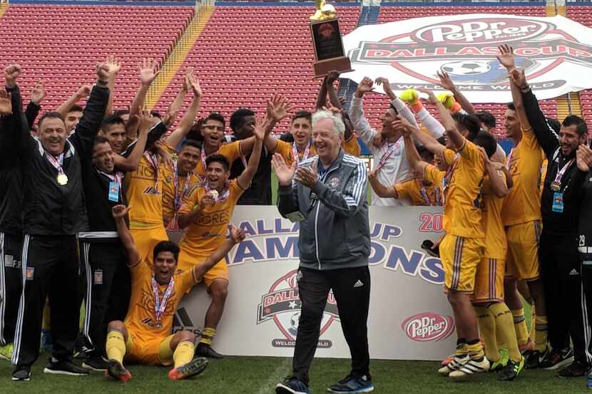 Gordan Jago presents the "Boot and Ball" championship trophy to Tigres for winning the...