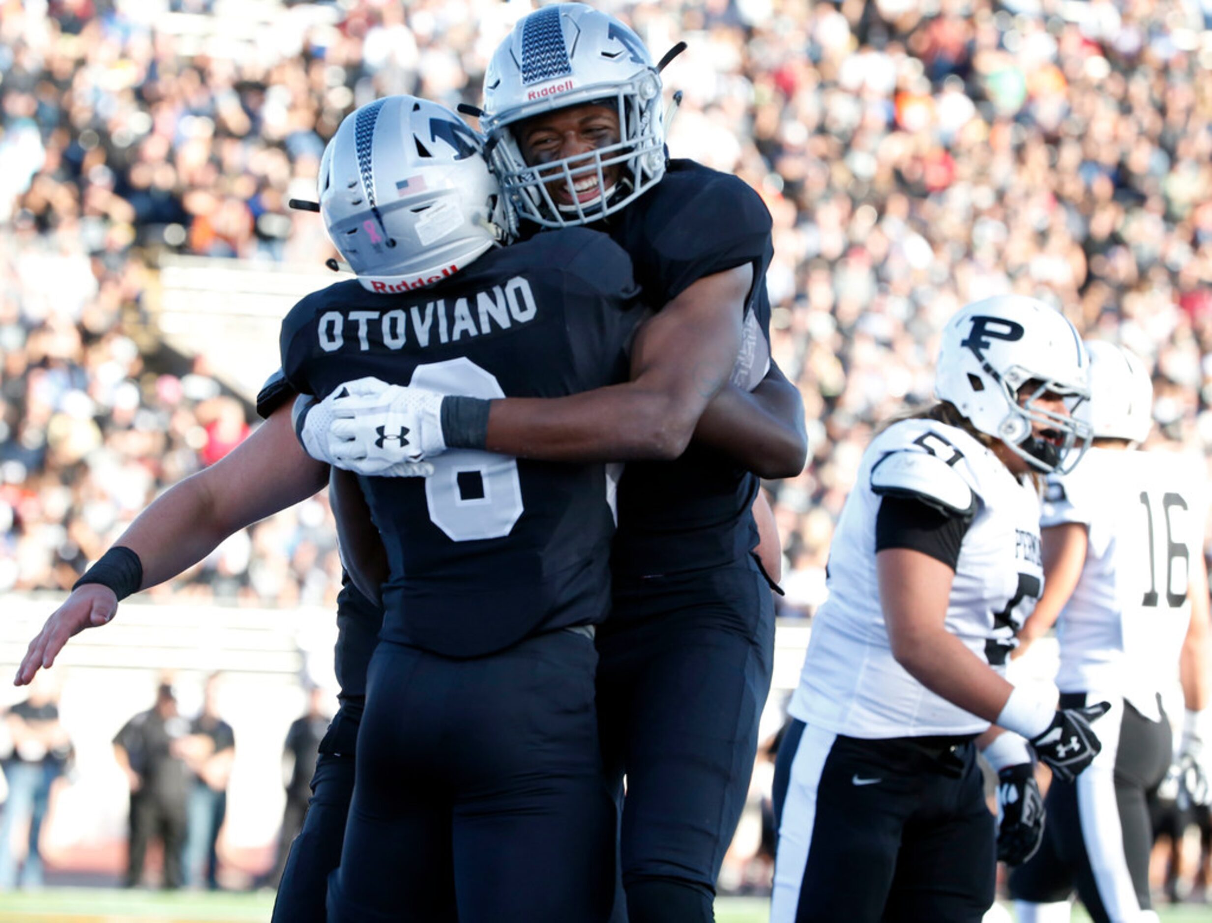 Juma Otoviano (8) and Antwone Parker (6), right celebrate an Arlington Martin touchdown...