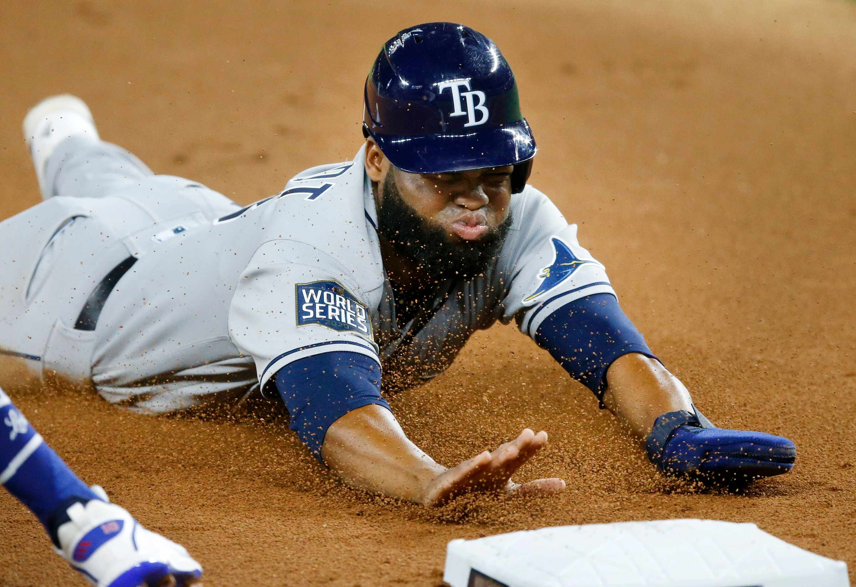 Tampa Bay Rays Manuel Margot (13) slides safely into third base on a fly ball by Joey Wendle...