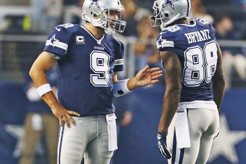 Dallas Cowboys quarterback Tony Romo (9) talks with wide receiver Dez Bryant (88) during a...