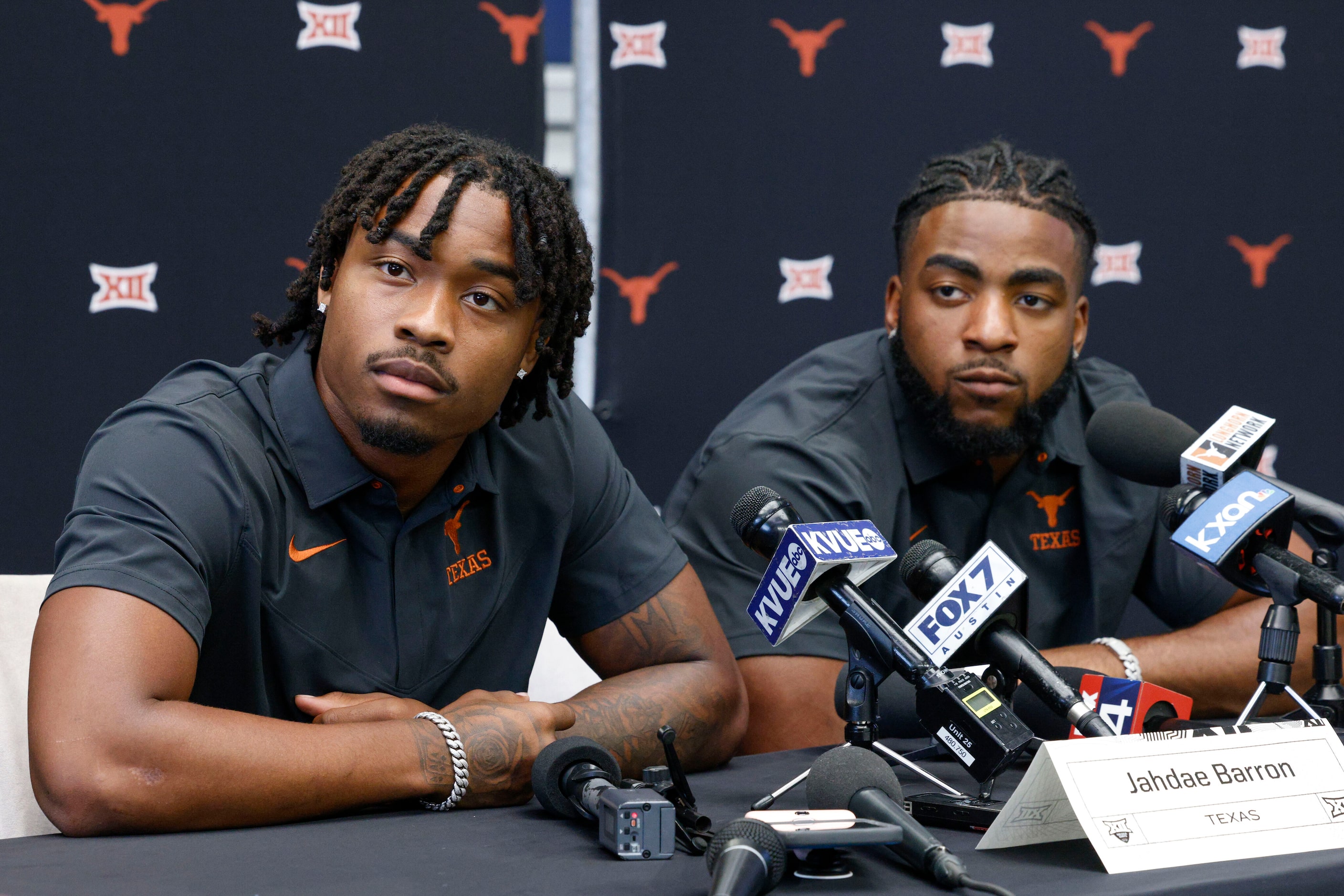 Texas defensive back Jahdae Barron (left) and linebacker Jaylan Ford listen to a question...