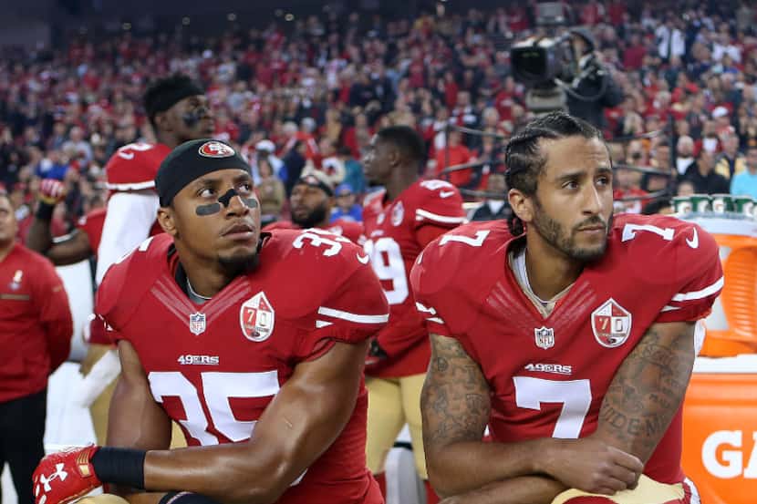 San Francisco 49ers Eric Reid (35) and Colin Kaepernick (7) take a knee during the National...