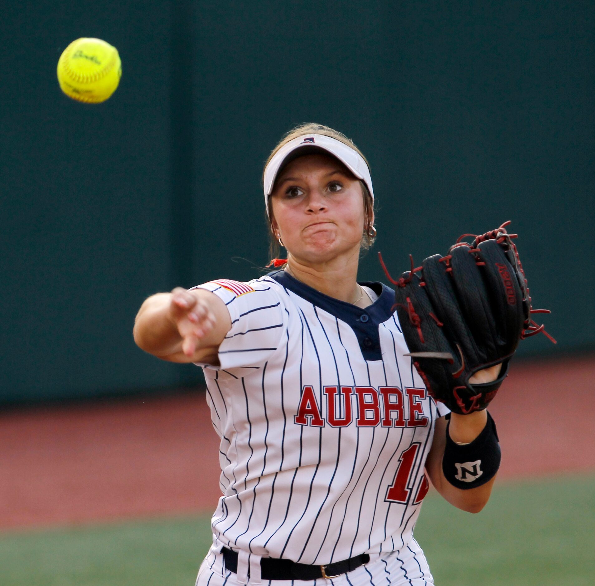 Aubrey 3rd baseman Brylie Dunkin (12) fires the ball to first for a ground out during the...