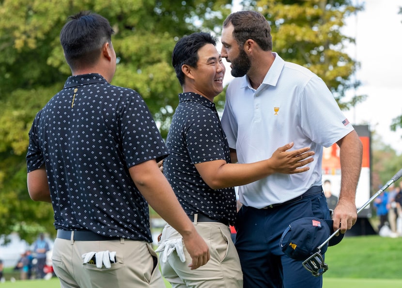 United States team members Scottie Scheffler, right, is congratulated by International Team...