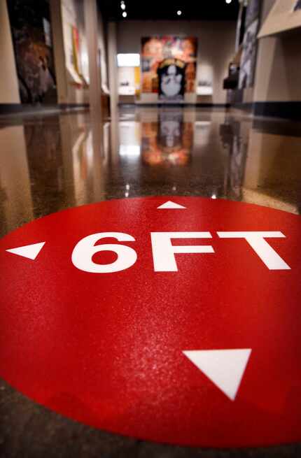 Markers on the floor will remind people to keep 6 ft. spacing while viewing exhibits in the...
