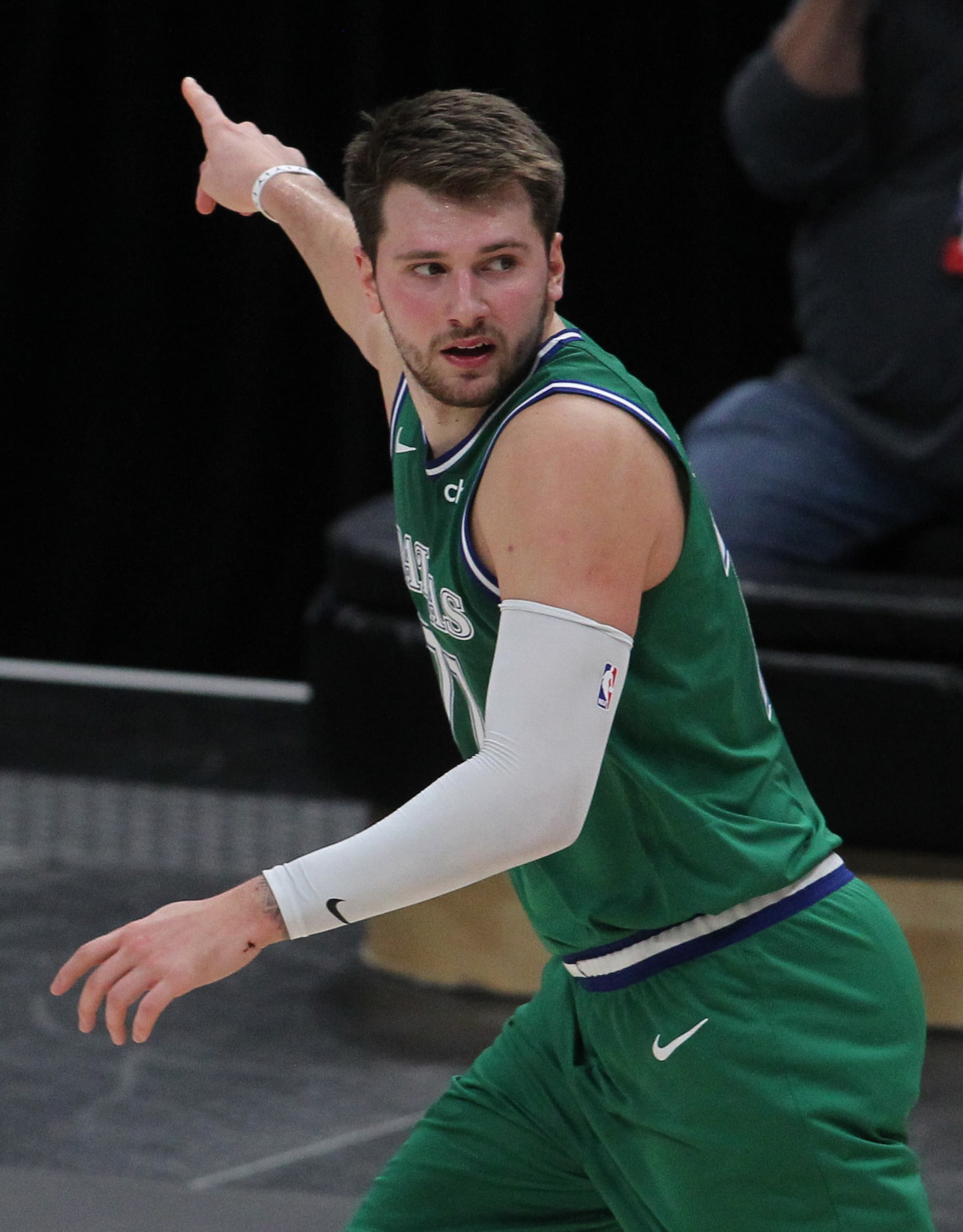 Dallas Mavericks point guard Luka Doncic (77) gestures as he heads back on defense after...