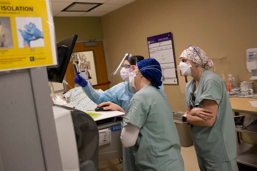 From left: Nurses Kelsey O’Meara, Noelle Hackfeld and Joanna Pless reviewed an intubated...
