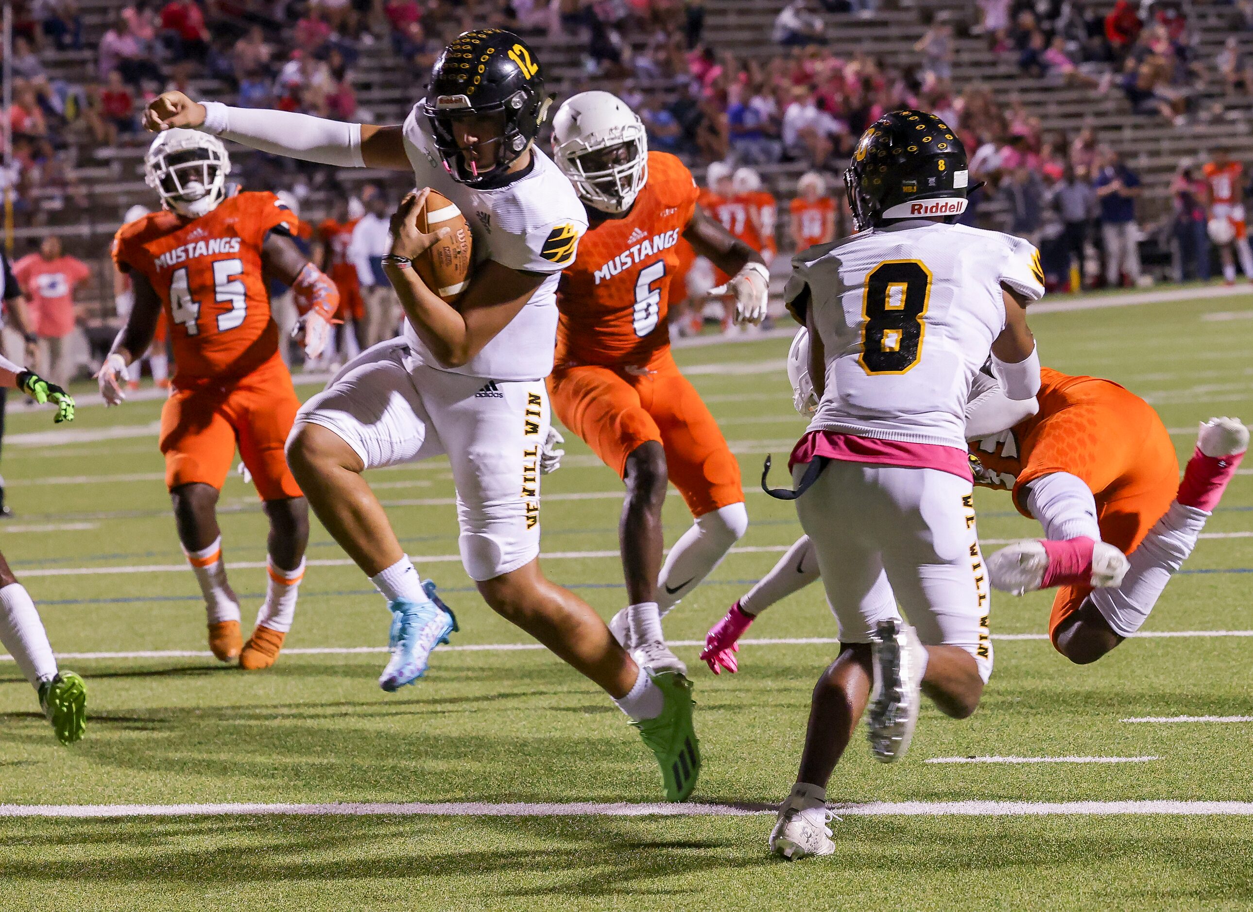 Garland’s quarterback Cergio Perez (12) runs in for a touchdown interceptions during the...