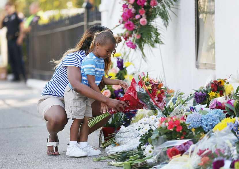 
Tamara Holmes and her son, Trenton, placed flowers in front of Emanuel AME Church on...