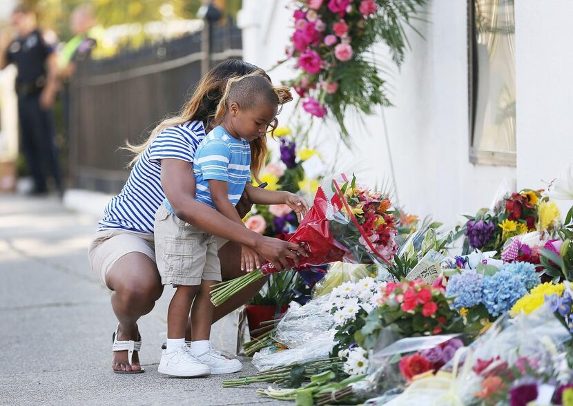 
Tamara Holmes and her son, Trenton, placed flowers in front of Emanuel AME Church on...