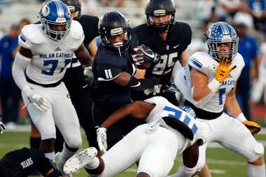 Bishop Lynch RB Charles Crawford (11) picks up yardage in heavy traffic during the first...