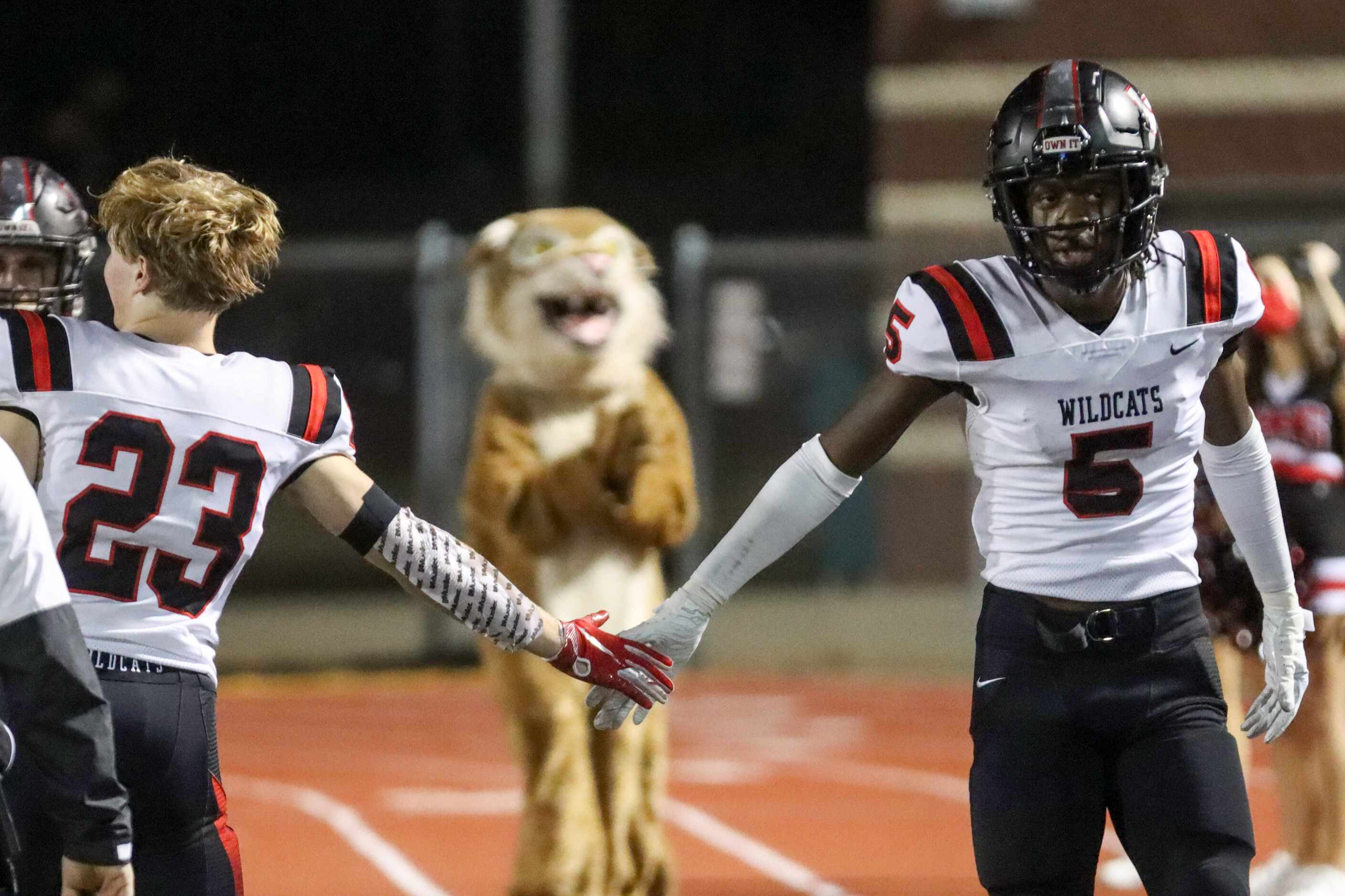 Lake Highlands wide receiver Ladavion Osborn (5) high fives wide receiver Ian Moudy (23)...