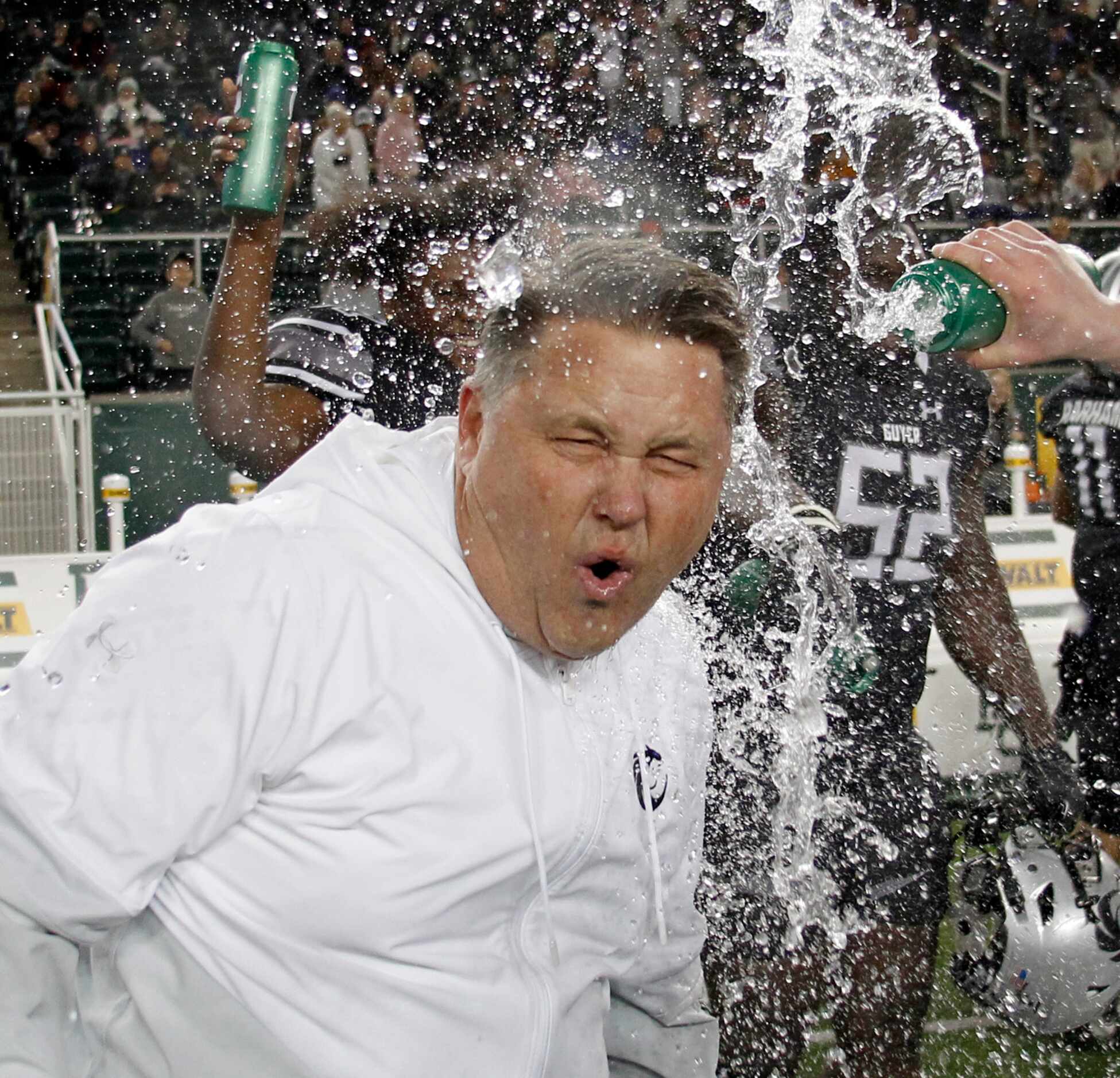 Denton Guyer head coach Rodney Webb reacts as he is doused with water during the waning...