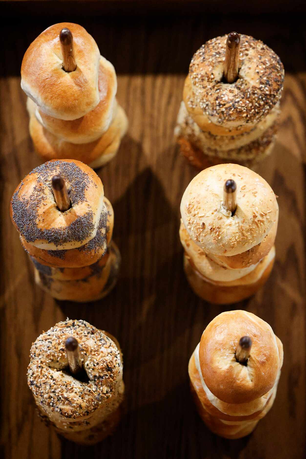 Bagels at Trades Delicatessen in Dallas are displayed on pegs (pictured) or in baskets (not...