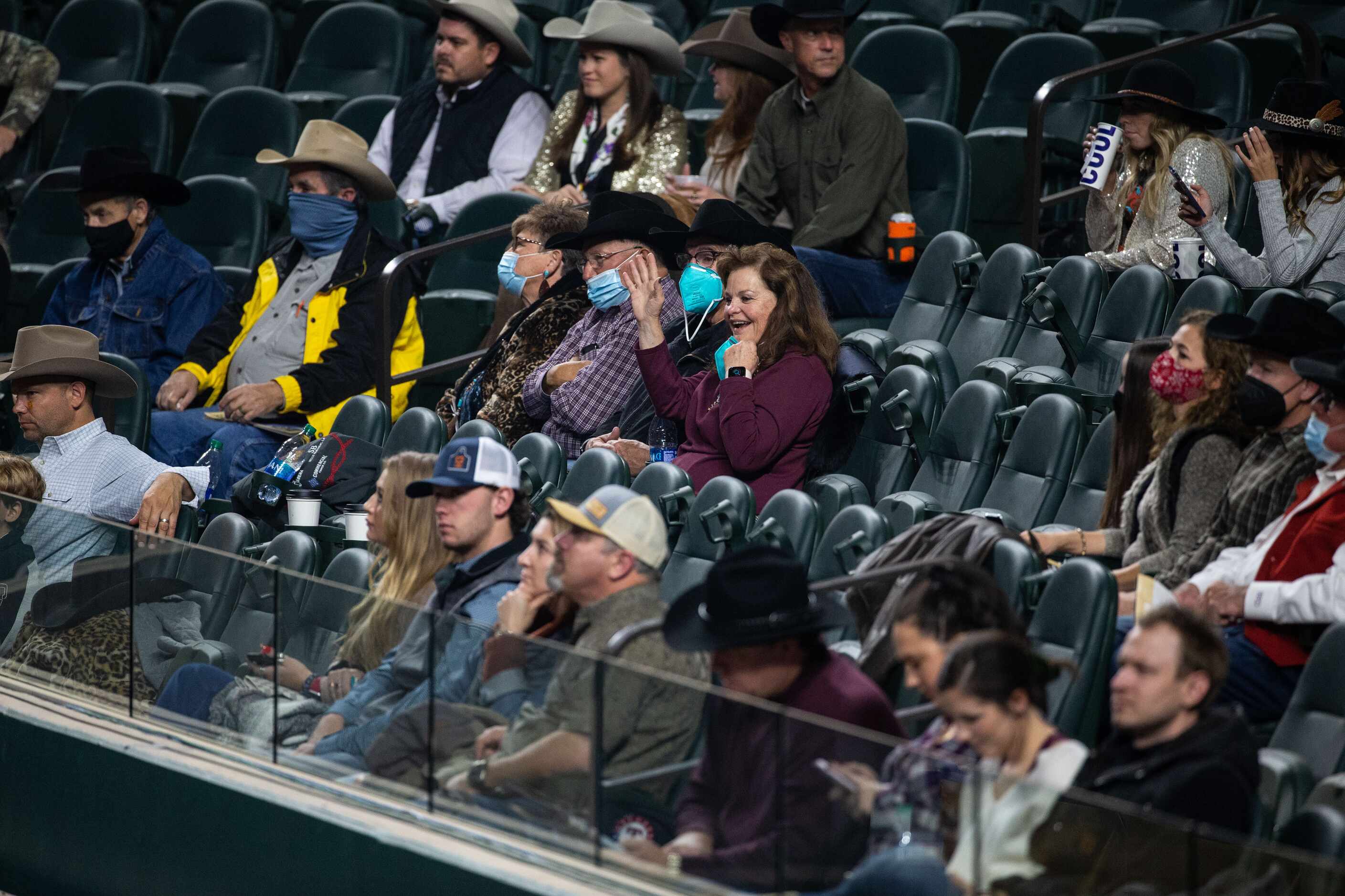 Crowd members watch PRCA contestants compete during the opening night of the National Finals...