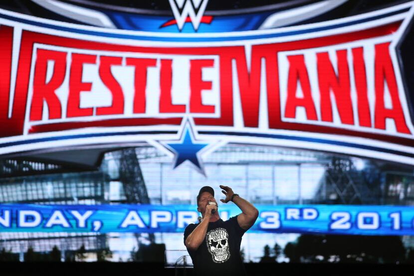 “Stone Cold” Steve Austin, cq, cheers on fans at the start of events at the Wrestlemania...