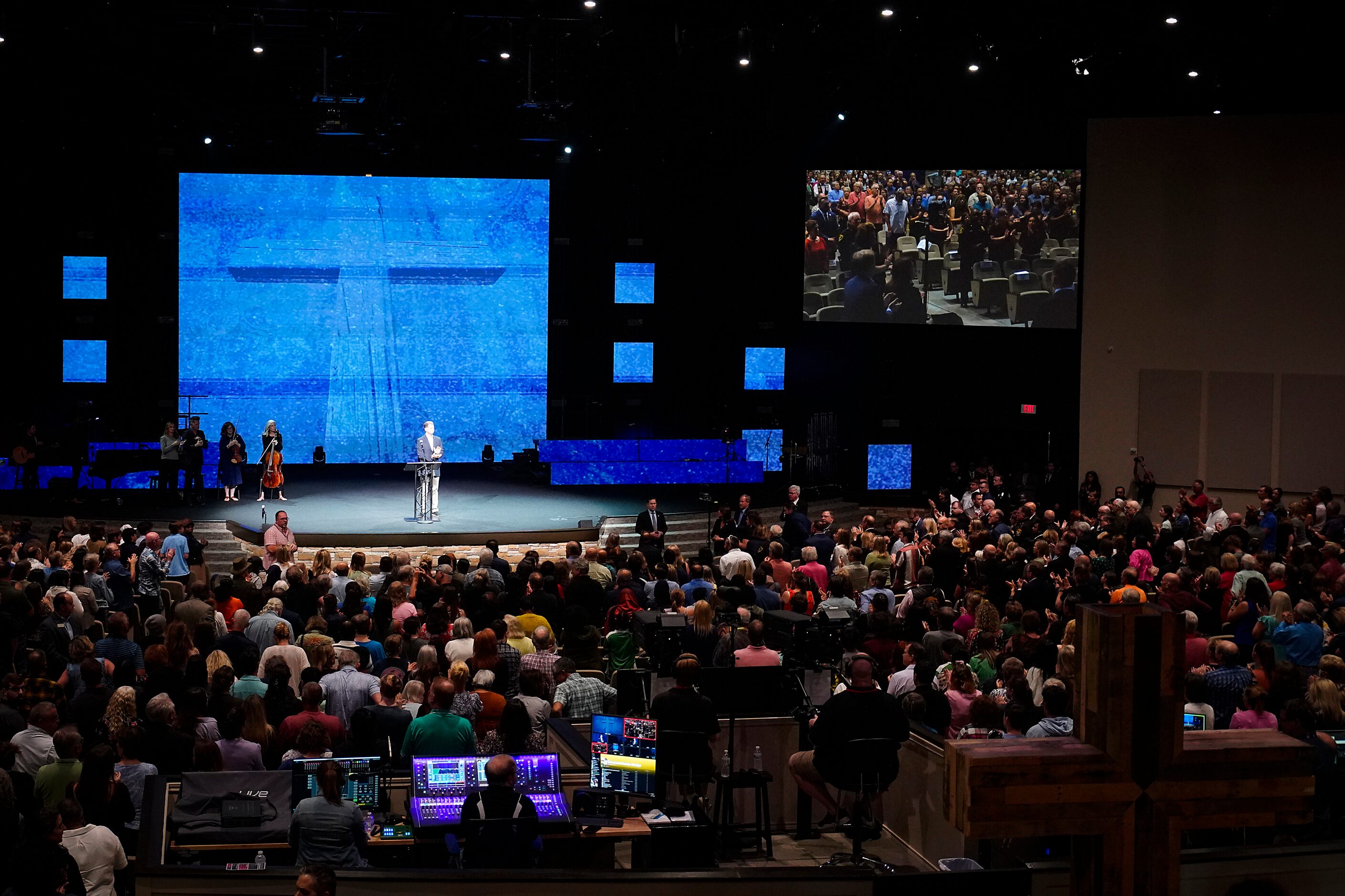 First responders are given a standing ovation during a vigil at Cottonwood Creek Church a...