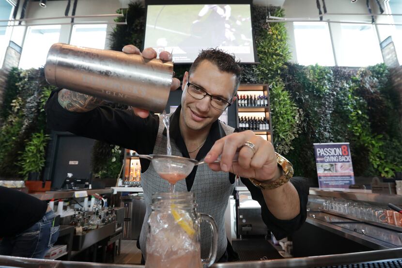 The greenery on the wall behind bartender Nick Vasinda is made of real plants, watered for 2...