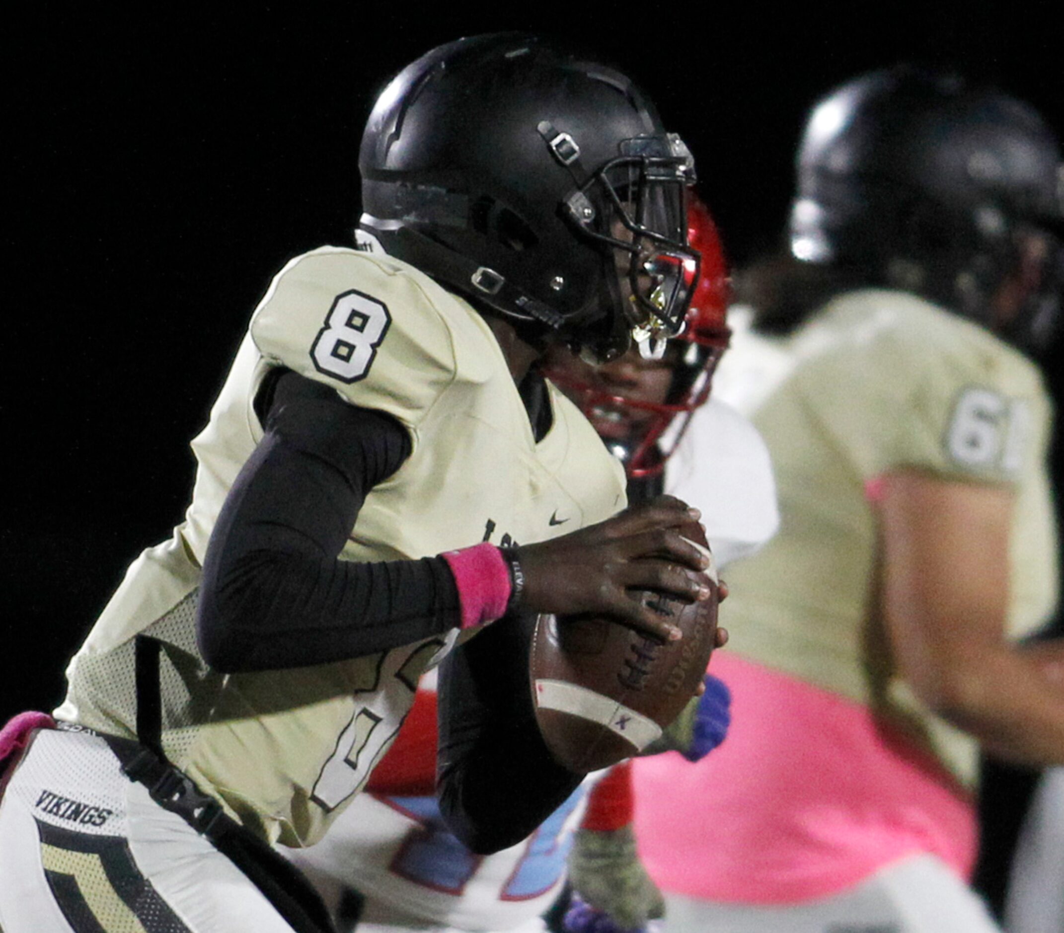 Dallas Pinkston quarterback Camyri Childress (8) rolls out in search of a receiver during...