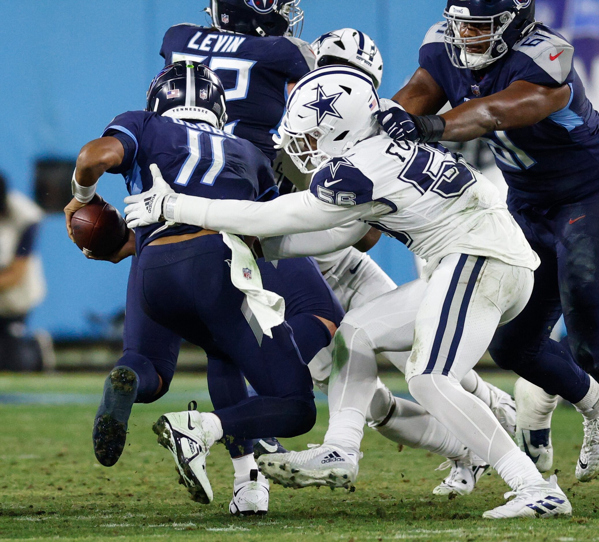 Dallas Cowboys defensive end Dante Fowler Jr. (56) forces a fumble from Tennessee Titans...