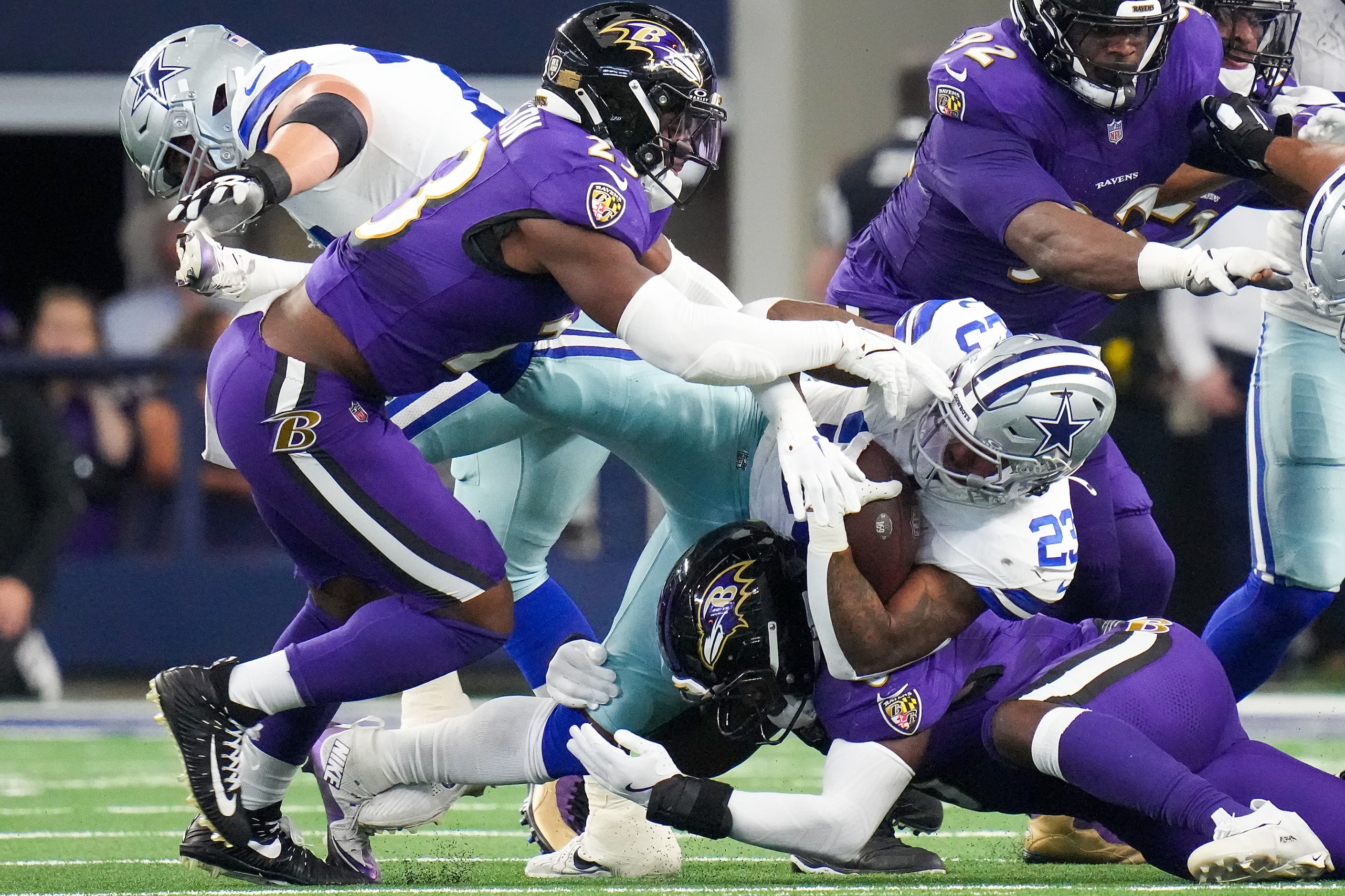 Dallas Cowboys running back Rico Dowdle (23) is brought down by the Baltimore Ravens defense...